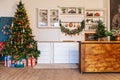 Christmas living room with a Christmas tree, gifts. Dining room. Beautiful New Year decorated classic home interior. Winter backgr Royalty Free Stock Photo