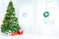 Christmas living room with a Christmas tree, gifts and a large window. Beautiful New Year decorated classic home interior Royalty Free Stock Photo