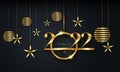 2022 Christmas luxury holiday banner with gold handwritten Merry Christmas and Happy New Year, gold colored Christmas balls Royalty Free Stock Photo