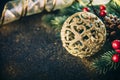 Christmas luxury still life with golden christmas ornament, fir tree and gold ribbon on dark vintage table. Closeup of luxury home Royalty Free Stock Photo