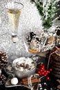 Christmas, luxury xmas, silver cup of sweet cream, and glass of champagne on black table, with sweets, cinnamon, aniseed, winter