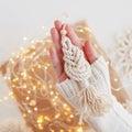 Christmas macrame toys in child hand. White background. Natural materials - cotton thread, wood beads and stick. Eco decorations, Royalty Free Stock Photo