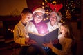 Christmas magic book and family Royalty Free Stock Photo