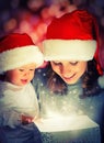 Christmas magic gift box and a happy family mother and baby Royalty Free Stock Photo