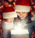 Christmas magic gift box and a happy family mother and baby Royalty Free Stock Photo