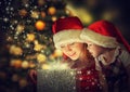 Christmas magic gift box and a happy family mother and daughter baby girl Royalty Free Stock Photo