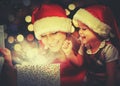 Christmas magic gift box and a happy family mother and daughter baby girl Royalty Free Stock Photo