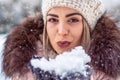 Christmas magic. Woman blowing magic snow. Royalty Free Stock Photo