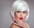 Christmas makeup and manicure nails. Surprised woman face posrtrait. blonde girl with short bob white hair style and red lips Royalty Free Stock Photo