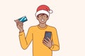 Christmas man shopaholic holds phone and credit card for online purchase goods with courier delivery