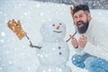 Christmas man in snow. Enjoying nature wintertime. Handsome bearded man, father in winter clothes. Christmas Man and