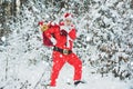 Christmas man in snow. Happy new year. Santa Claus pulling huge bag of gifts on white nature background. Santa in the Royalty Free Stock Photo