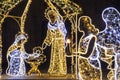 Christmas Manger scene art made many led bright garland lit lamps against old ancient Magdeburg Dom Church background