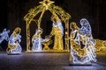 Christmas Manger scene art made many led bright garland lit lamps against old ancient Magdeburg Dom Church background