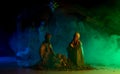 Christmas manger scene with figurines including Jesus, Mary, Joseph, lamb. Biblical Mary holding baby Jesus. Christmas