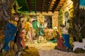 Photo of Christmas Manger scene with figurines including Jesus, Mary, Joseph, sheep and magi