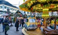 Christmas market with children`s carousel, food and drink stalls.