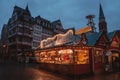 Christmas market spirit during snow night. Royalty Free Stock Photo