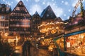 Christmas market spirit during snow night. Royalty Free Stock Photo