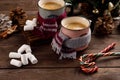 Christmas marshmallows and New Year decorations and sweet canes on a wooden background. Winter holidays, new year mood. Copy space Royalty Free Stock Photo