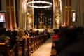Christmas mass in the Catholic cathedral, people are sitting on the benches, near the altar, the Christmas choir performs