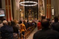 Christmas mass in the Catholic cathedral, people are sitting on the benches, near the altar, the Christmas choir performs