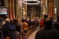 Christmas mass in the Catholic cathedral, people are sitting on the benches, near the altar, the Christmas choir performs