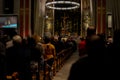 Christmas mass in the Catholic cathedral, people are sitting on the benches, near the altar, the Christmas choir performs