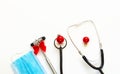 Christmas medical flatlay. Medical stethoscope, neurological hammer, gift, Christmas decorations on a white background. Copyspace
