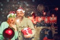 Christmas man hold bomb. Happy couple in Santa hat at Xmas family party. New year party in home. Royalty Free Stock Photo