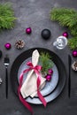 Christmas menu concept . Flat lay with Xmas decorations, dark plates, fork and knife with napkin Royalty Free Stock Photo