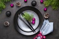 Christmas menu concept . Flat lay with Xmas decorations, dark plates, fork and knife with napkin Royalty Free Stock Photo