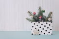 Christmas minimal flat lay composition with fir branches, shiny christmas balls, wooden star  in polka dot gift bag on pastel Royalty Free Stock Photo