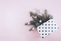 Christmas minimal flat lay composition with fir branches, shiny christmas balls, wooden star  in polka dot gift bag on pastel Royalty Free Stock Photo