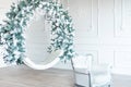 Christmas minimalism. White sitting ring with christmas decoration in modern white classical interior. Minimal christmas