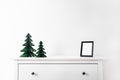 Christmas mock up with black frame and Honeycomb tree paper decor. Square frame on a wooden shelf against a white wall