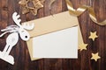 Christmas mockup envelope with blank paper on brown wooden background. Letter to Santa Claus. Christmas winter setting -