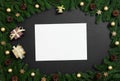 Christmas mockup with fir branches and golden decorations on a black background. Happy New Year. Space for text. Top view, flat Royalty Free Stock Photo