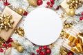 Christmas mockup with gifts or presents boxes, snowy fir tree and holiday decorations on white wooden table top view. Flat lay. Royalty Free Stock Photo