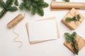 Christmas mockup greeting card with envelope on wooden white background with fir tree branches and happy new year Royalty Free Stock Photo