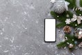 christmas mockup with space for text. christmas advertising, app template. hand holding phone with empty screen on table Royalty Free Stock Photo