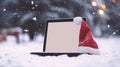 Christmas Mockup: Tablet with Santa Hat on Winter Holiday Background. Royalty Free Stock Photo