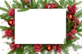 Christmas mockup with a white blank sheet of paper on top of Christmas tree branches decorated with glass balls and viburnum Royalty Free Stock Photo