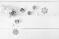 Christmas mockup on a white wooden background with snowflakes, a deer and a cone. Flat lay, top view Royalty Free Stock Photo