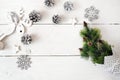 Christmas mockup on a white wooden background with snowflakes, a deer and a Christmas tree. Flat lay, top view Royalty Free Stock Photo