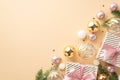 Christmas mood concept. Top view photo of present boxes with ribbon bows transparent gold and pink baubles balls fir branches in Royalty Free Stock Photo