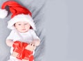 Christmas mood. Cute four month old baby in a red Santa Claus hat