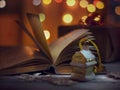 Christmas mood. Opened book of fairy tales and Christmas decorations on a wooden table. Royalty Free Stock Photo