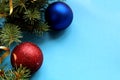 Christmas mood spruce branches and toys on a blue background Royalty Free Stock Photo