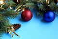 Christmas mood spruce branches and toys on a blue background Royalty Free Stock Photo